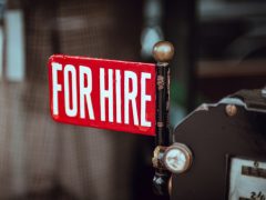 shallow focus photography of red and white for hire signage